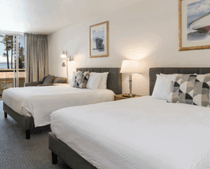 Firelite Lodge - Double Queen room double queen room with two beds, lamps and artwork