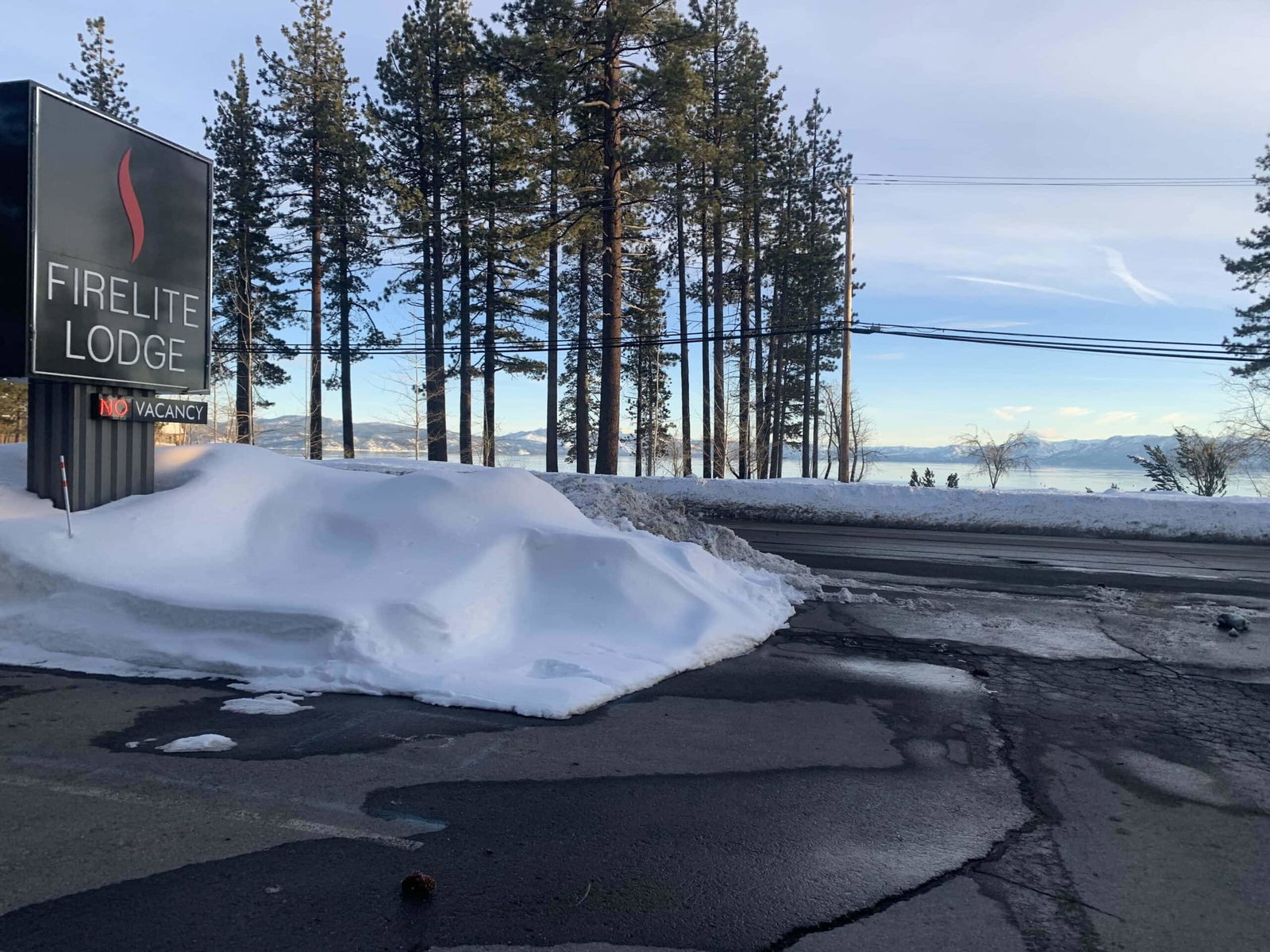 Firelite Lodge winter in Tahoe firelite lodge in winter with snow around the sign and trees