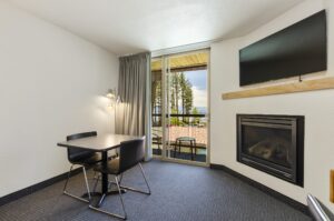 Fireplace and lakeview at firelite lodge fireplace, table, and balcony with lake tahoe view
