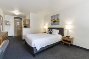 queen room at firelite lodge queen room with bed and nightstand
